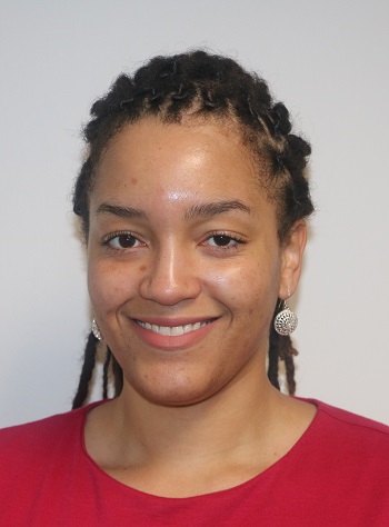 Headshot image of a smiling young woman in a red shirt.