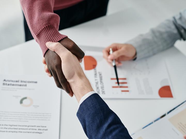 handshake over business documents