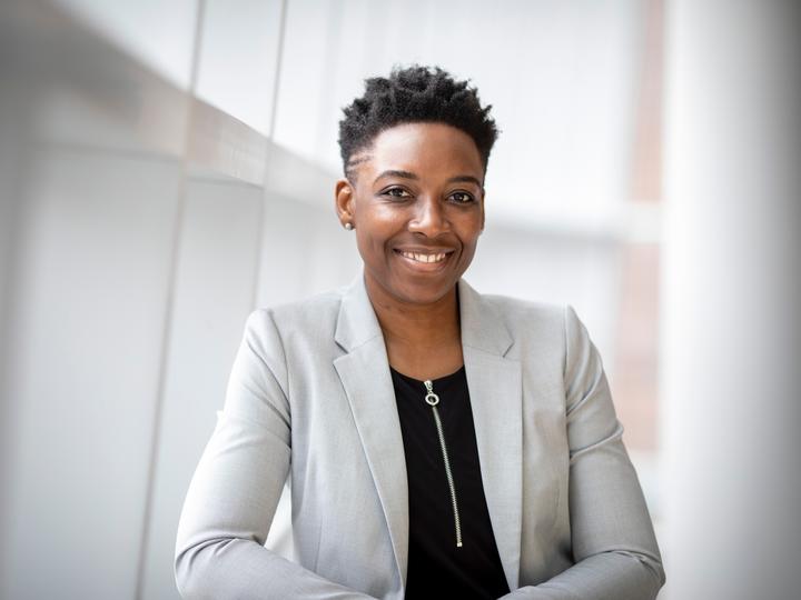 Headshot image of a young professional African American woman smiling at the camera.