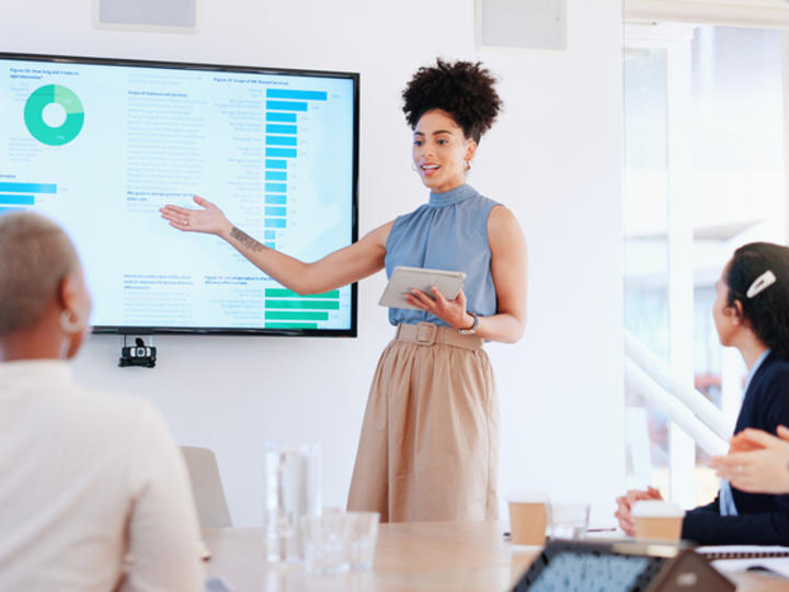 Woman presenting data on screen