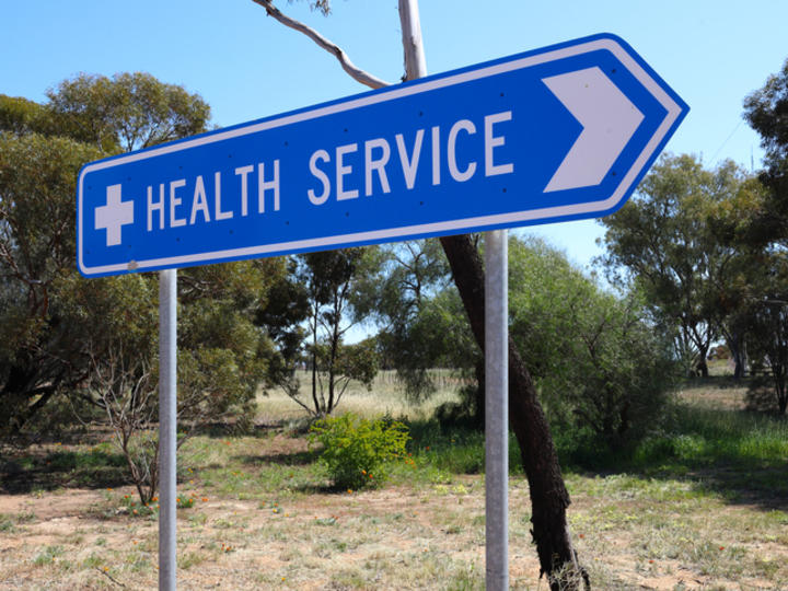 Blue sign that reads Health Service in rural area
