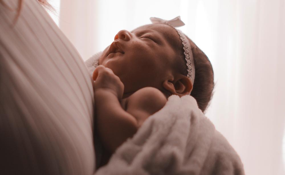 Newborn baby in mother's arms.