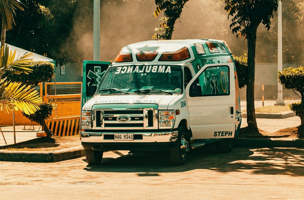 A parked ambulance with its front doors open.