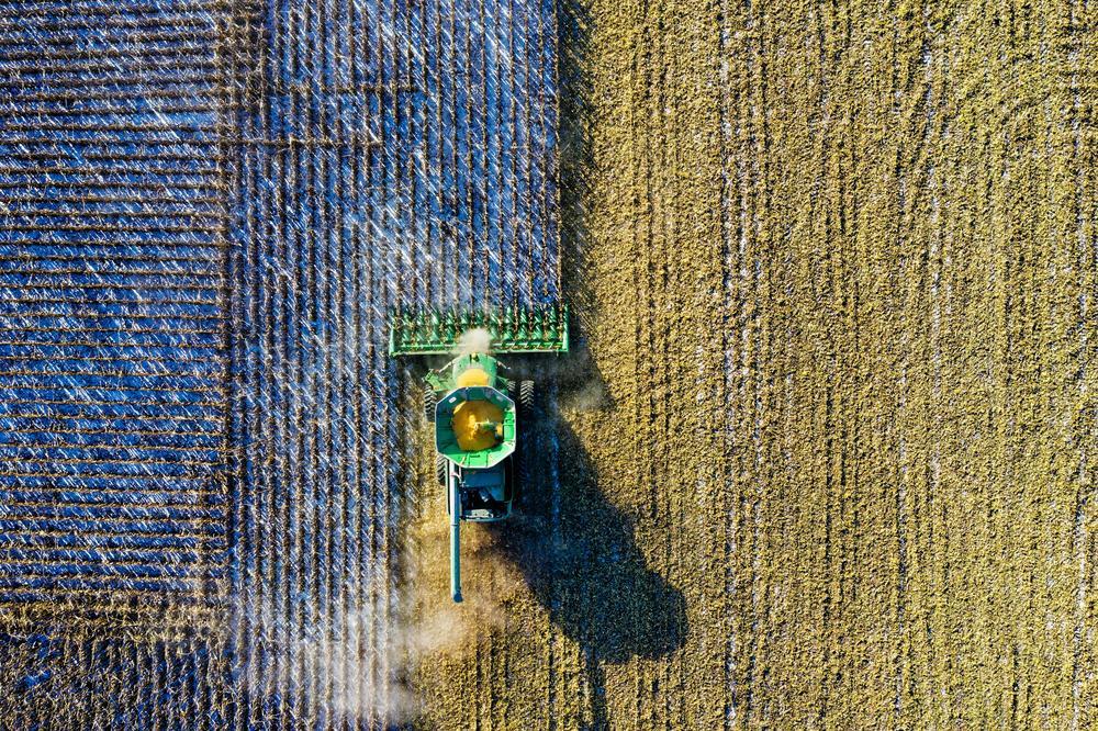 Aerial view of tractor and farm.