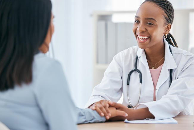 Female doctor consulting with female patient 
