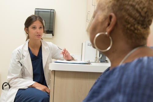 Woman having a check up with female nurse