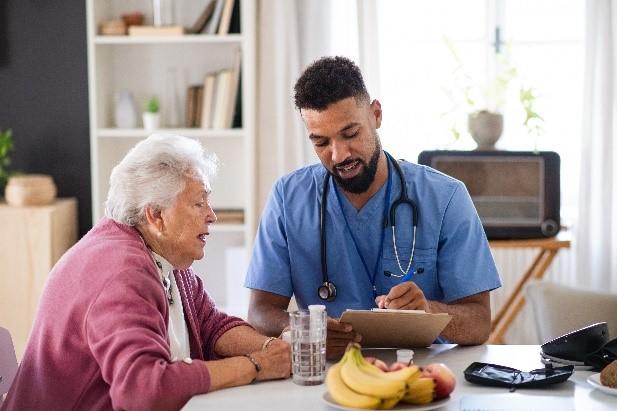 Home health services worker assisting elderly patient