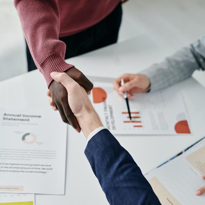 handshake over business documents