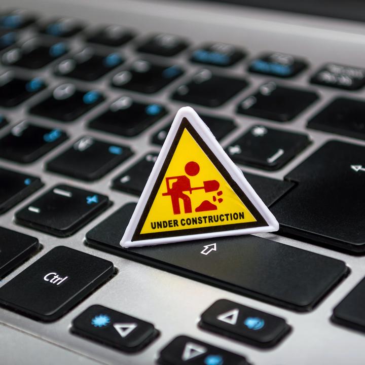 Under construction sign on computer keyboard.