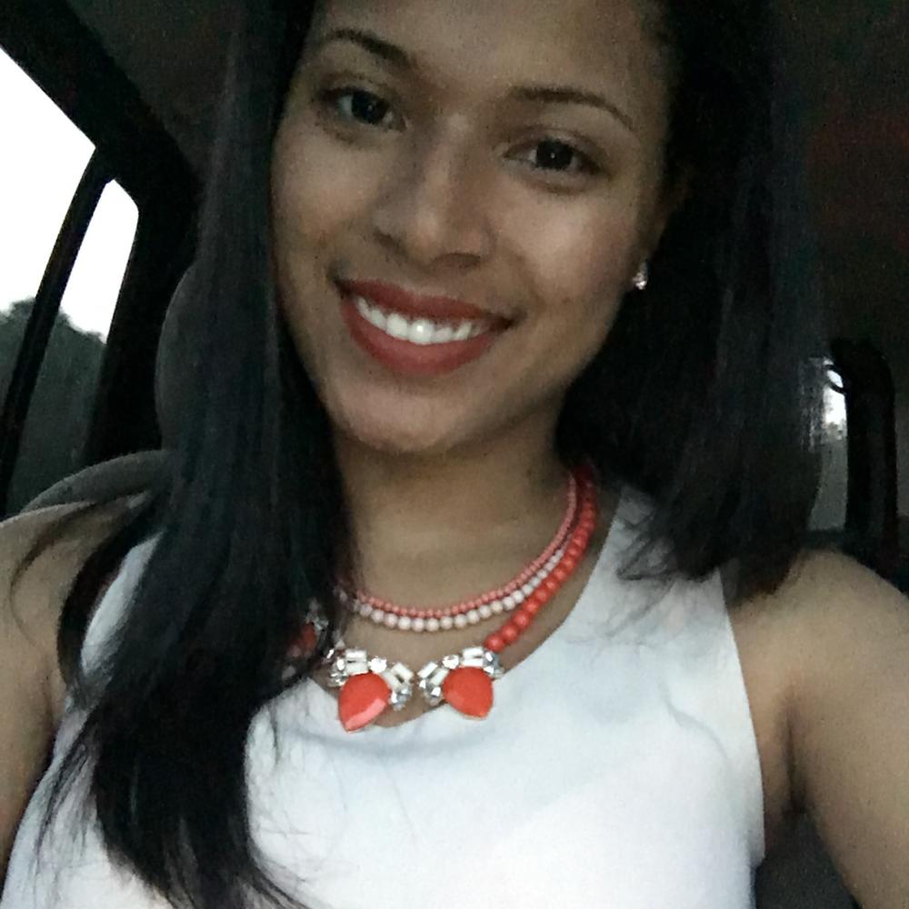 Photo of smiling female employee sitting in car