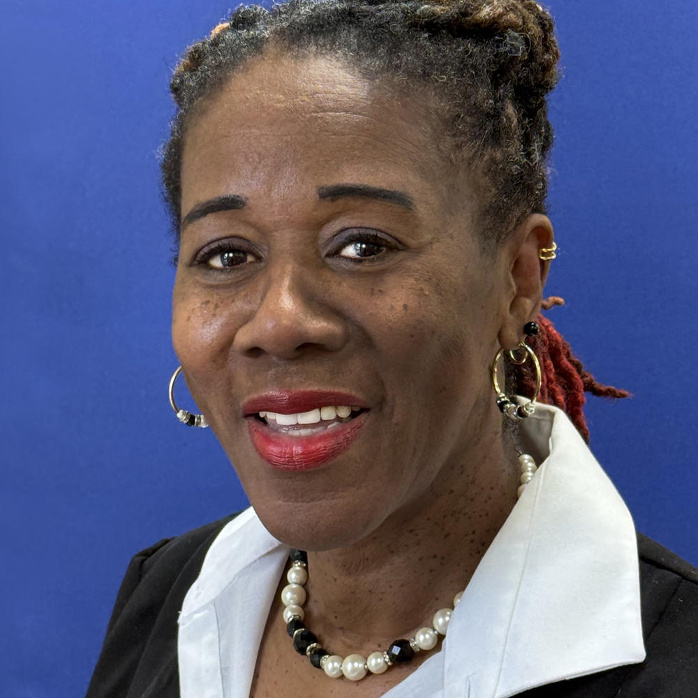 Headshot of female employee on blue background 