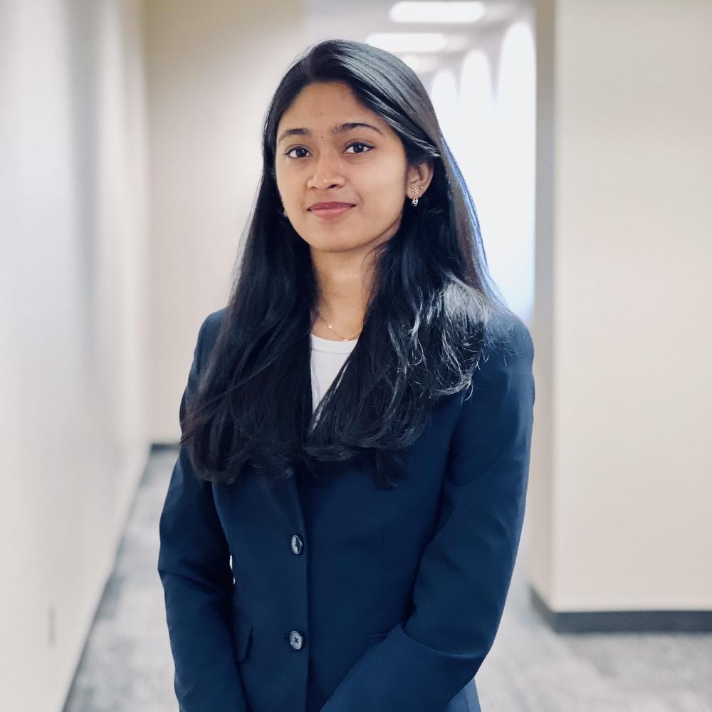Photo of female employee standing in hallway