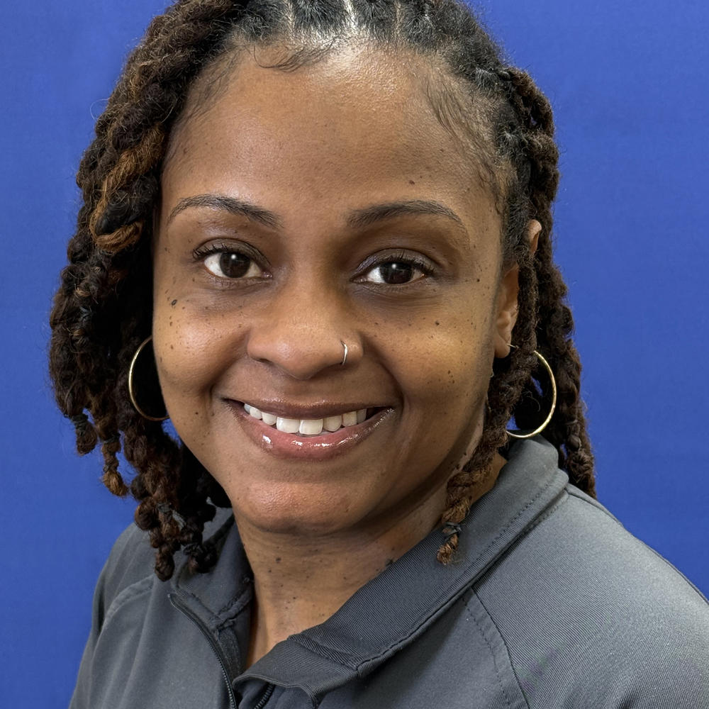 Headshot of female employee on blue background 