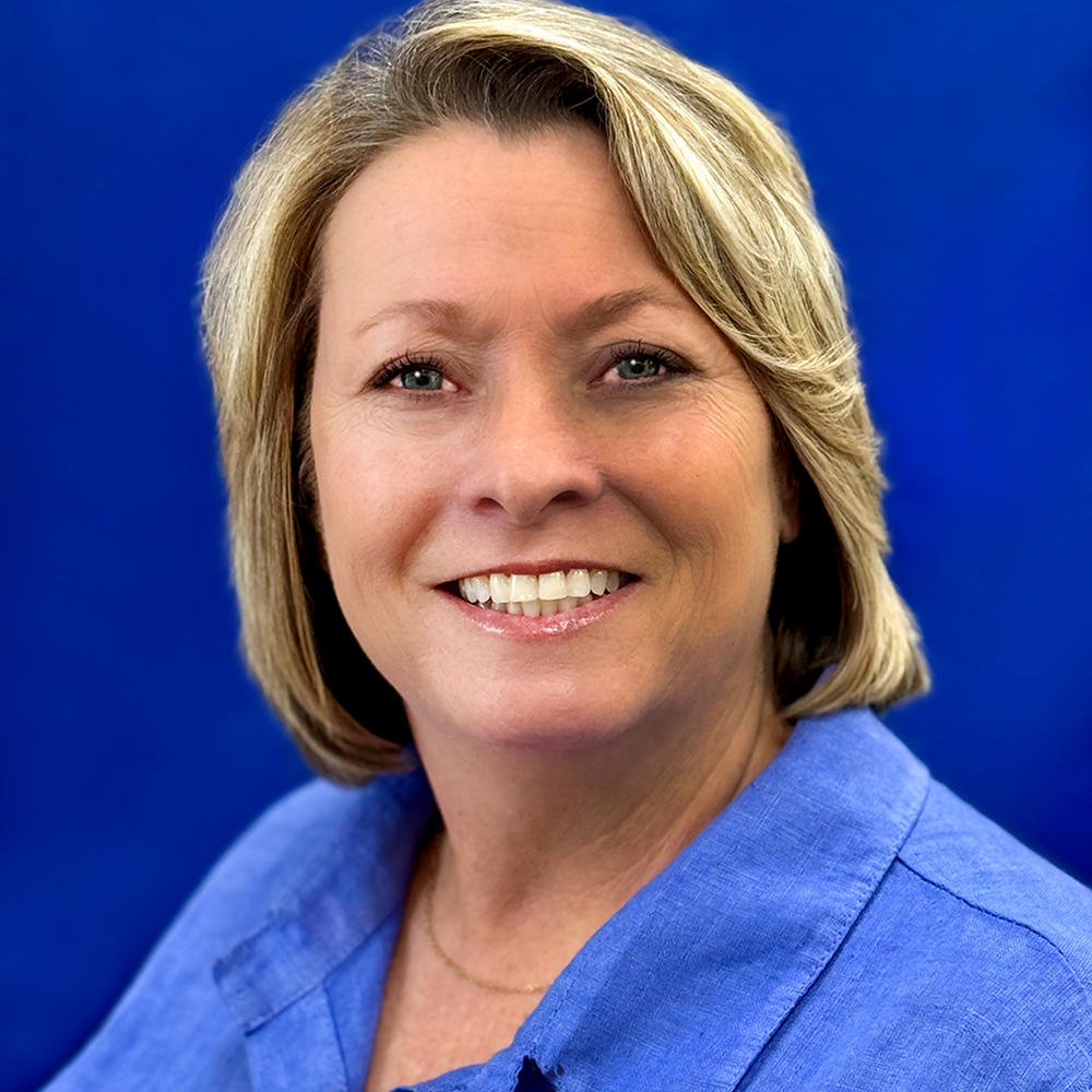 Female headshot on blue background