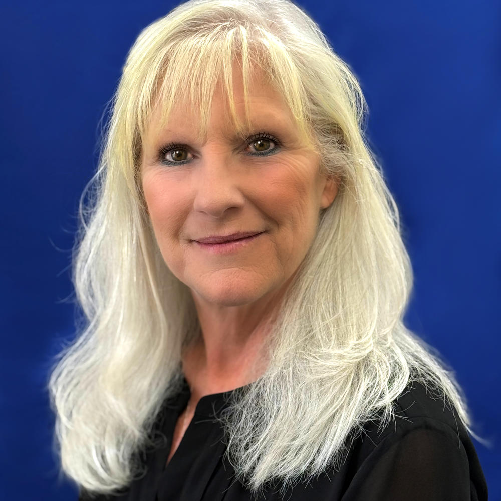 Female headshot on blue background