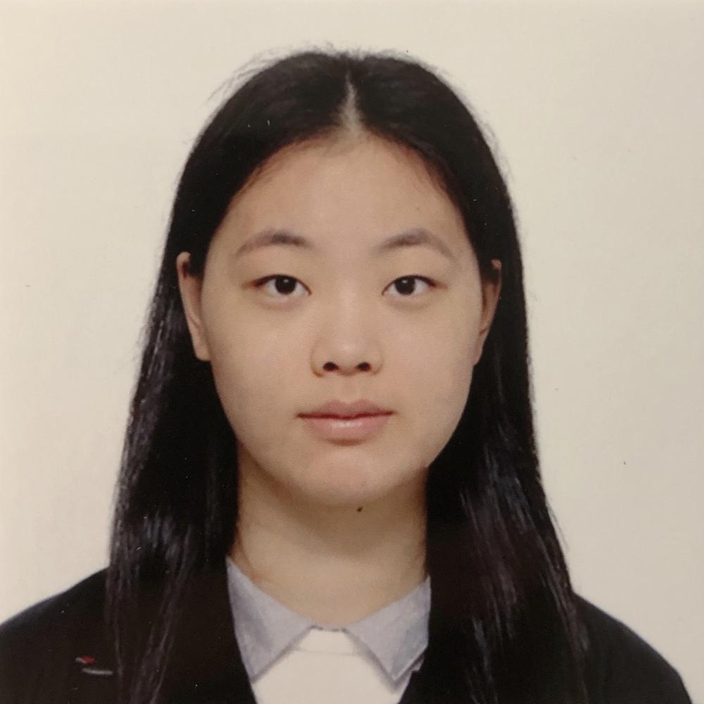 Headshot of female employee on tan background