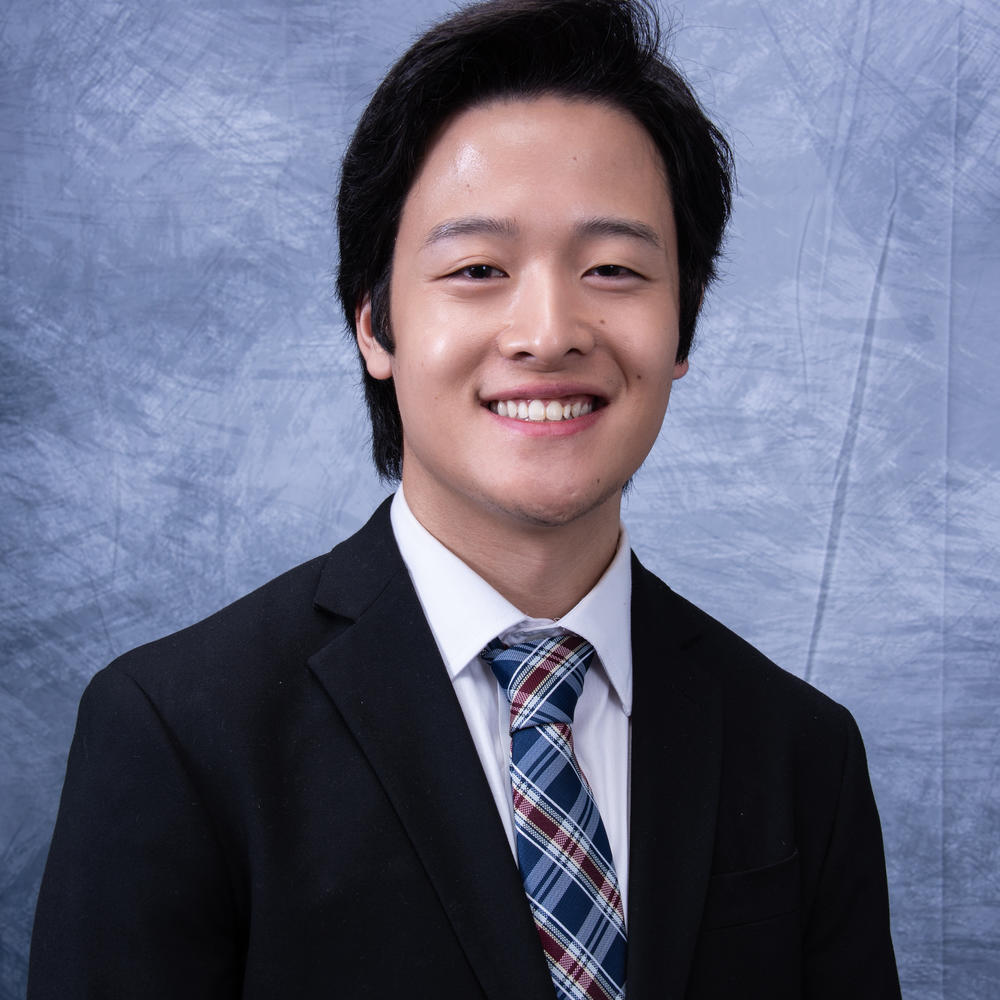 Male employee headshot on light blue background