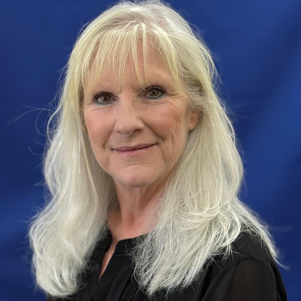 Headshot of female employee on blue background 