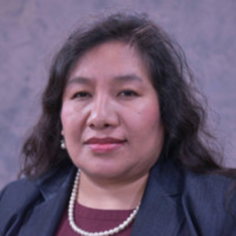 Headshot of woman in front of gray background