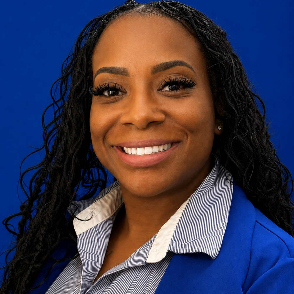 Headshot of female employee smiling in front of blue background 